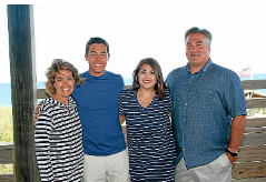 Chris Wenzler on the beach with his family Melissa, Oliver and Madeline.